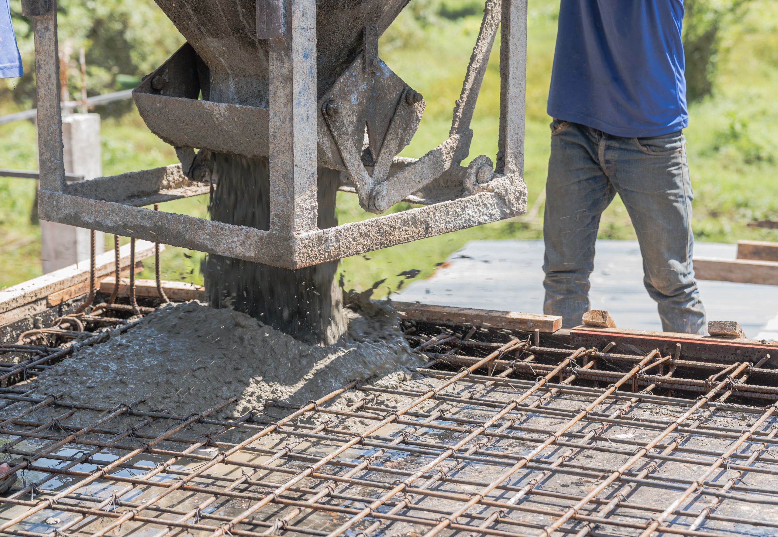 worker-open-cement-bucket-tank-machine-on-fence-fr-2023-12-14-02-53-36-utc-scaled.jpg